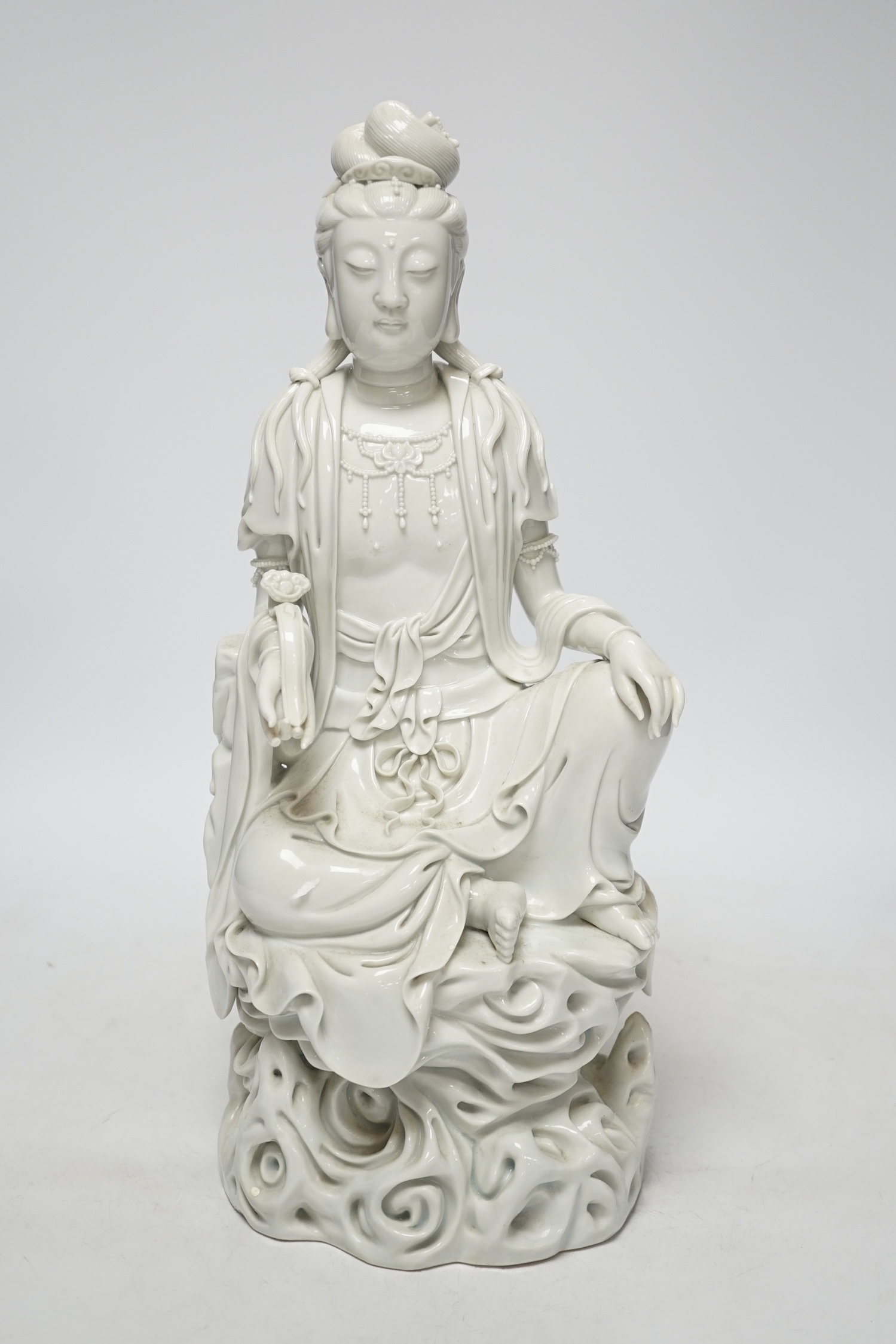 A late 19th / early 20th century Chinese blanc de Chine seated figure of Guanyin, impressed mark to back, 38cm